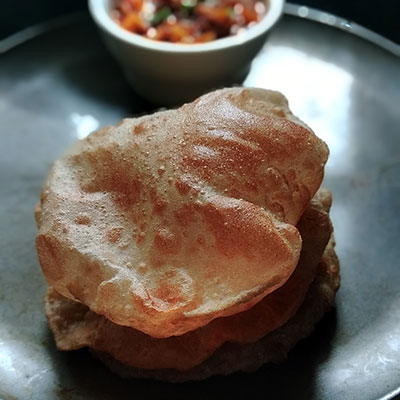 Poori is that staple food of India that knows no boundaries. The deep fried puri made with wheat flour (atta) is one of the delicious Indian flatbreads just like roti.